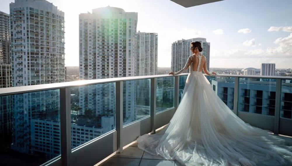 bride standing on balcony with skyline views
