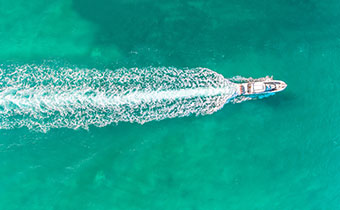 Boat gliding through blue water