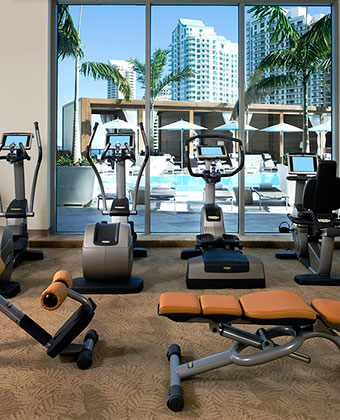 Fitness Center with machines overlooking the pool